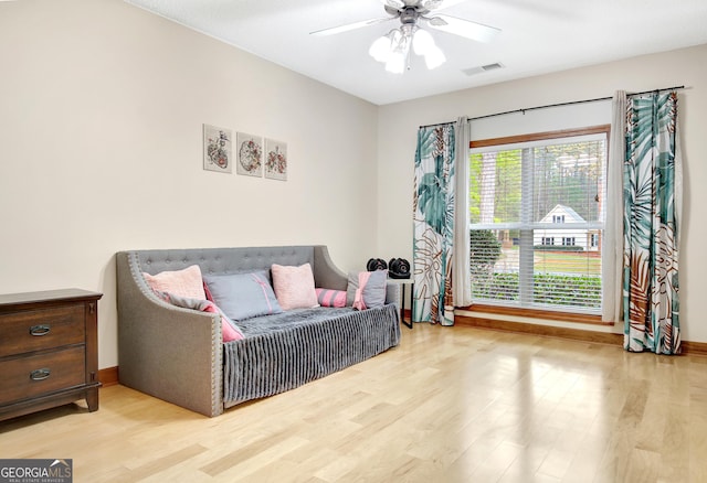 sitting room featuring ceiling fan, baseboards, light wood-style flooring, and visible vents