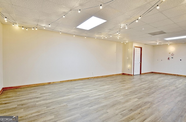 empty room featuring wood finished floors and baseboards