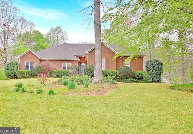 ranch-style home with brick siding and a front yard