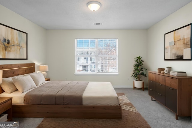 bedroom with light carpet, baseboards, and visible vents
