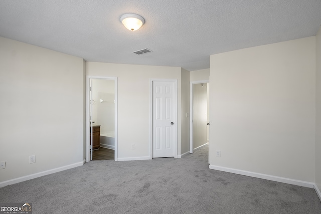unfurnished bedroom featuring carpet, baseboards, and visible vents
