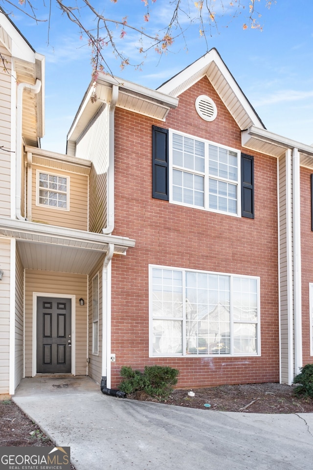 townhome / multi-family property with brick siding
