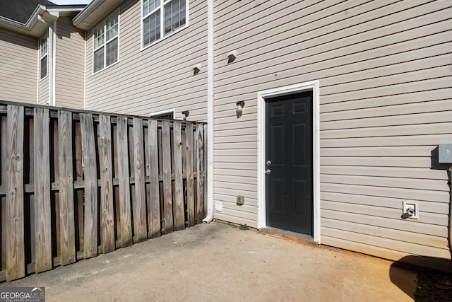entrance to property with a patio and fence