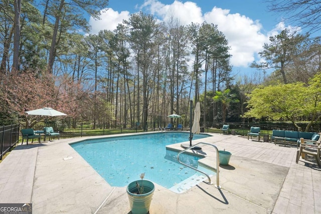 view of pool featuring outdoor lounge area, a fenced in pool, fence, and a patio
