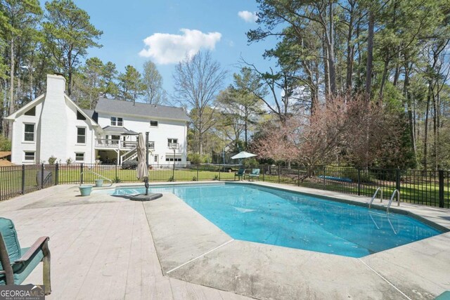 view of swimming pool with a patio, fence, and a fenced in pool