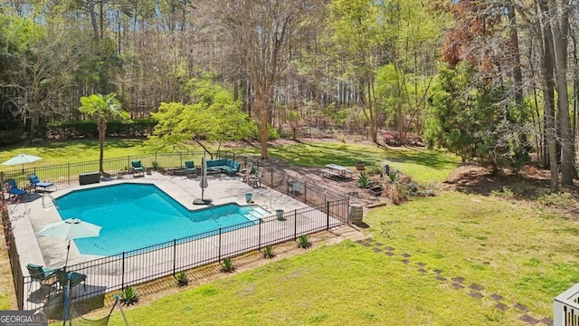 view of swimming pool with a fenced in pool, fence, a yard, and a patio area