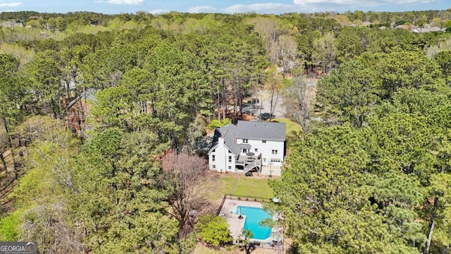 birds eye view of property featuring a view of trees