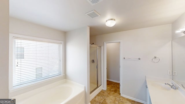full bathroom featuring a stall shower, visible vents, vanity, and a garden tub
