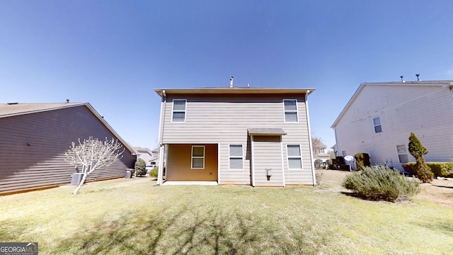 rear view of house with a lawn