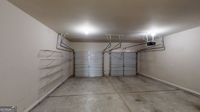 garage featuring baseboards and a garage door opener