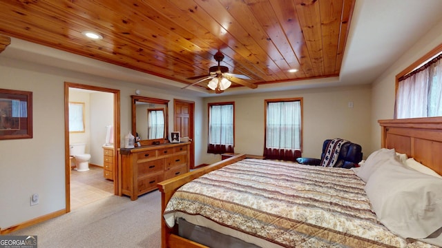 bedroom featuring wooden ceiling, a raised ceiling, multiple windows, and light carpet