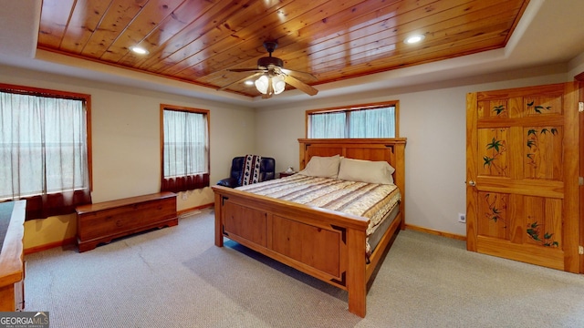 carpeted bedroom with a tray ceiling, wooden ceiling, and baseboards