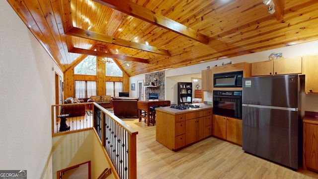 kitchen with light wood finished floors, a stone fireplace, a peninsula, wood ceiling, and black appliances