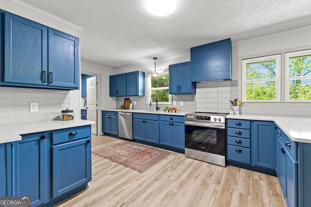 5697 Yatesville Hwy, Yatesville, GA 31097 - kitchen with custom range hood, blue cabinets, and appliances with stainless steel finishes