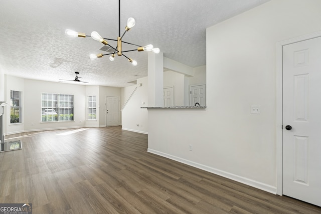 4917 Walden Lake Sq, Decatur, GA 30035 - unfurnished living room with a chandelier, a textured ceiling, a ceiling fan, and dark wood finished floors