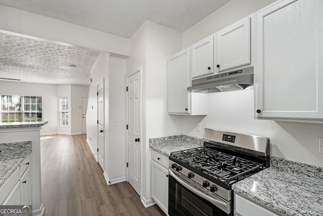 4917 Walden Lake Sq, Decatur, GA 30035 - kitchen featuring stainless steel gas stove, extractor fan, dark wood-type flooring, a textured ceiling, and white cabinets