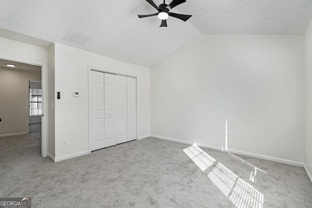 4917 Walden Lake Sq, Decatur, GA 30035 - unfurnished bedroom featuring carpet, a textured ceiling, vaulted ceiling, a closet, and a ceiling fan