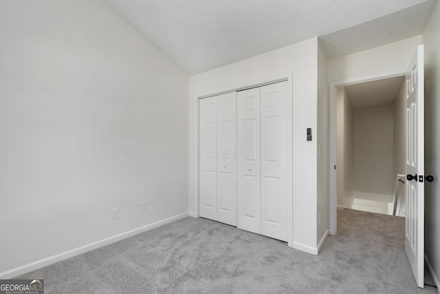4917 Walden Lake Sq, Decatur, GA 30035 - unfurnished bedroom with carpet, a closet, and vaulted ceiling