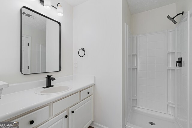 4917 Walden Lake Sq, Decatur, GA 30035 - bathroom with vanity, a shower, and a textured ceiling