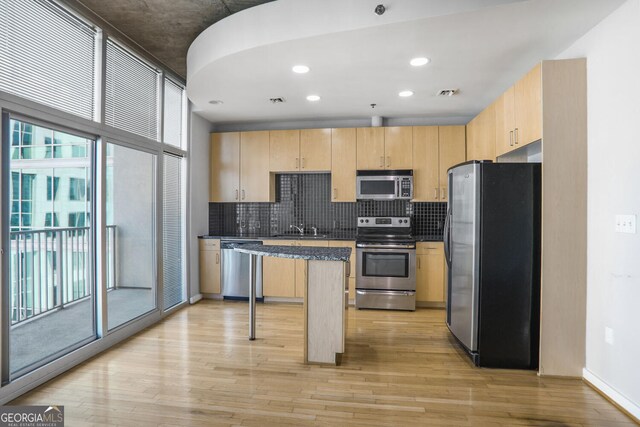 943 Peachtree St NE Unit 1003, Atlanta, GA 30309 - kitchen with stainless steel appliances, light brown cabinetry, light wood-style floors, a center island, and recessed lighting