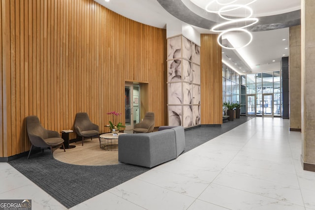 943 Peachtree St NE Unit 1003, Atlanta, GA 30309 - community lobby with wood walls, a towering ceiling, and a wall of windows