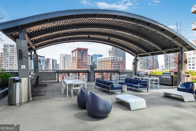 943 Peachtree St NE Unit 1003, Atlanta, GA 30309 - view of patio with a city view, outdoor lounge area, and a grill