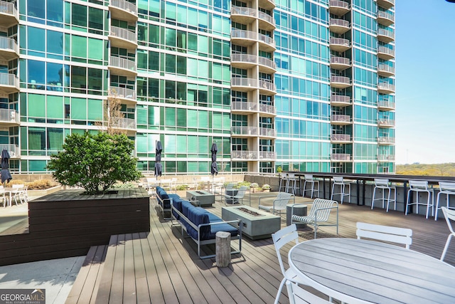943 Peachtree St NE Unit 1003, Atlanta, GA 30309 - wooden terrace with an outdoor living space with a fire pit