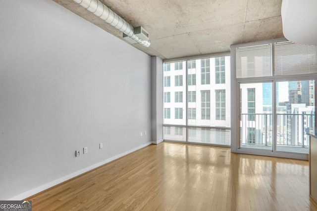 943 Peachtree St NE Unit 1003, Atlanta, GA 30309 - unfurnished room featuring wood finished floors and baseboards