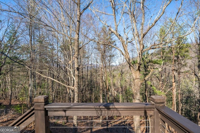 wooden deck featuring a wooded view