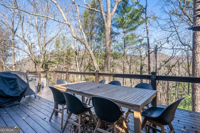 wooden terrace featuring outdoor dining space