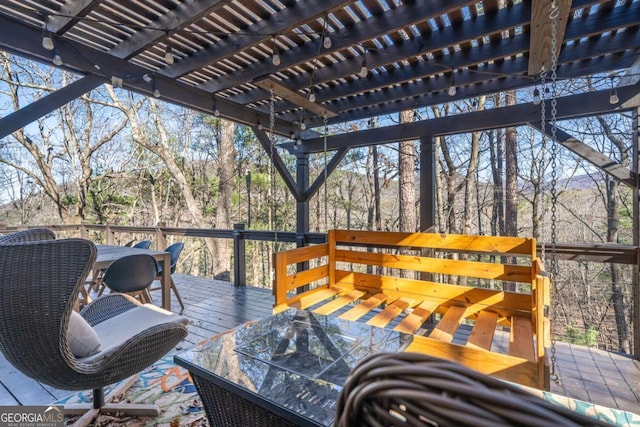 wooden deck featuring a pergola and outdoor dining space