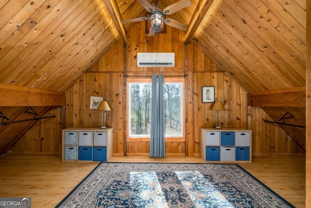 additional living space with lofted ceiling with beams, wood finished floors, a wall unit AC, and wood ceiling