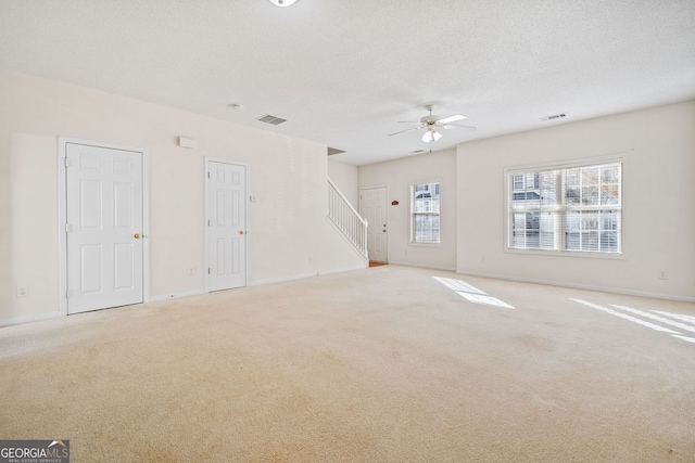 258 Venture Path, Hiram, GA 30141 - unfurnished living room featuring light colored carpet, ceiling fan, baseboards, and stairway