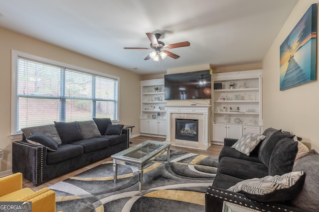 3450 Long Lake Dr, Douglasville, GA 30135 - living room featuring ceiling fan, light wood finished floors, and a glass covered fireplace