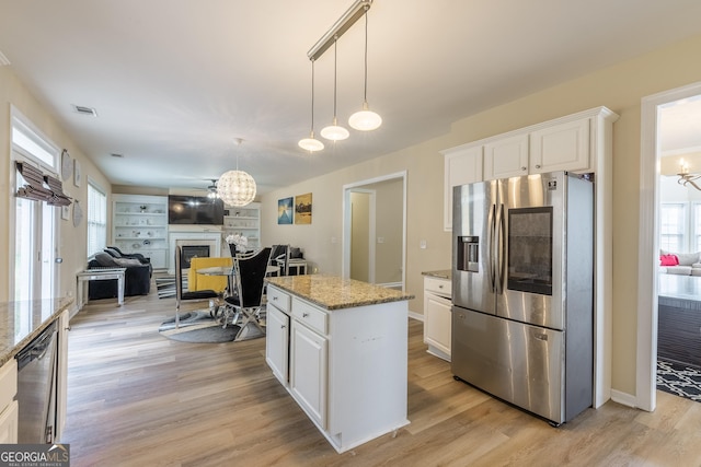 3450 Long Lake Dr, Douglasville, GA 30135 - kitchen with a wealth of natural light, white cabinetry, a fireplace, and stainless steel appliances