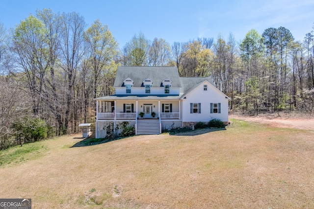 view of front of property with stairway, a front yard, and covered porch