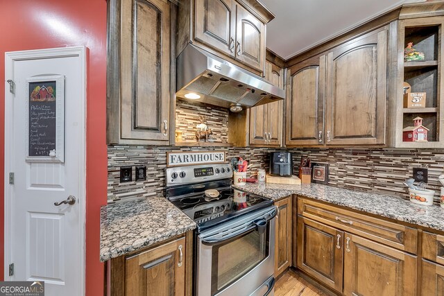 kitchen featuring decorative backsplash, under cabinet range hood, electric stove, and light stone counters