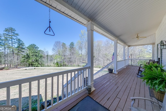 deck with a porch and a ceiling fan