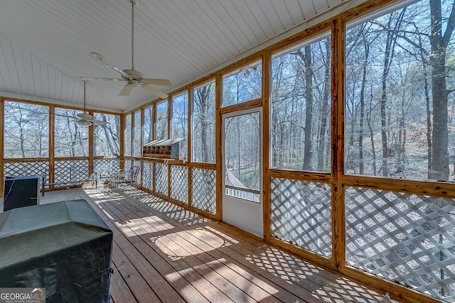 unfurnished sunroom with ceiling fan
