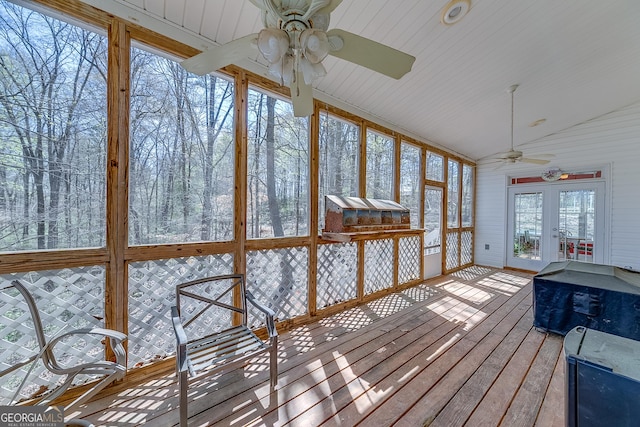 unfurnished sunroom with a ceiling fan and french doors
