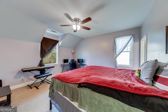 carpeted bedroom with lofted ceiling, visible vents, a ceiling fan, and baseboards