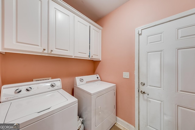 laundry room with cabinet space and washer and clothes dryer