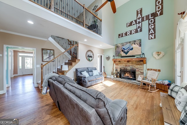 living room with stairway, baseboards, and wood finished floors