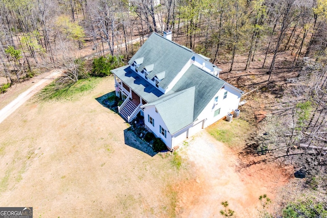 birds eye view of property featuring a view of trees