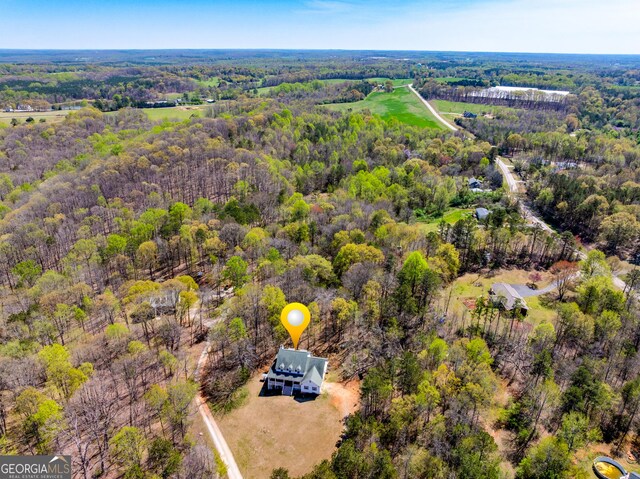 aerial view featuring a wooded view