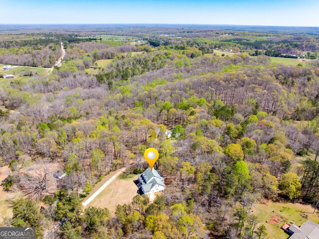 birds eye view of property with a forest view