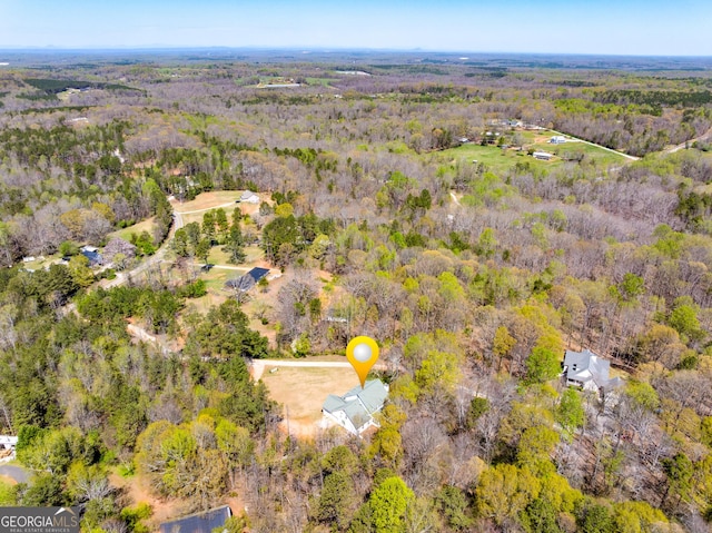 bird's eye view featuring a wooded view