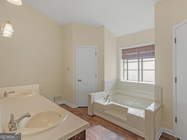 105 Overlook Dr, Mcdonough, GA 30252 - full bath featuring wood finished floors, a garden tub, and double vanity