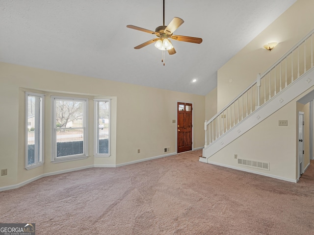 105 Overlook Dr, Mcdonough, GA 30252 - unfurnished living room featuring carpet flooring, vaulted ceiling, a ceiling fan, and stairs