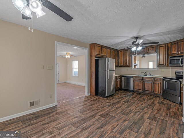 105 Overlook Dr, Mcdonough, GA 30252 - kitchen with stainless steel appliances, ceiling fan, dark wood-type flooring, light countertops, and a textured ceiling